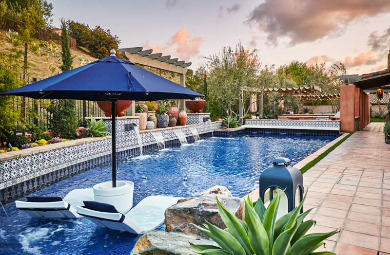 Pool with bar, hot tub and fountain built by Outdoor Hardscapes